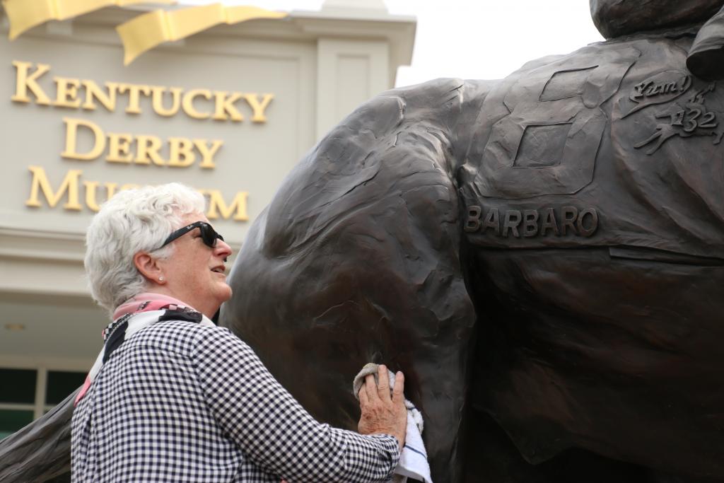 Artist Alexa King cleaning the Barbaro statue. (Julie June Stewart photo)